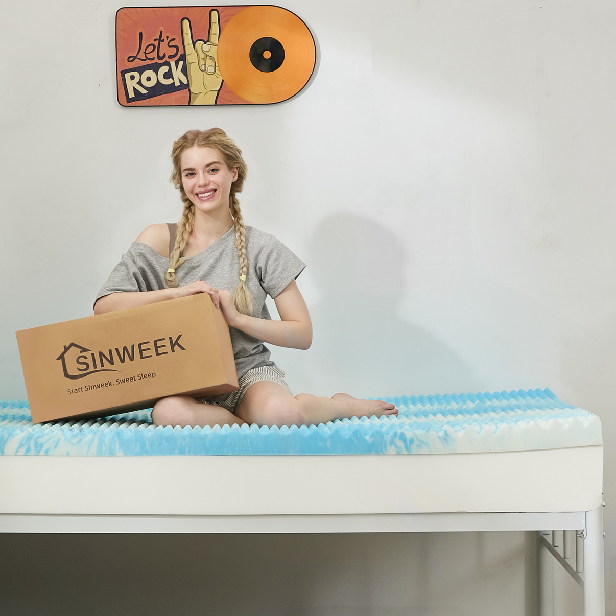 a girl sitting on a blue egg creat memory foam mattress topper