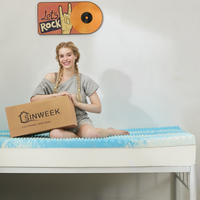 a girl sitting on a blue egg creat memory foam mattress topper